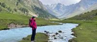 Trekker enjoys the beauty of the Tian Shan mountains, bubbling rivers and wild horses | SB